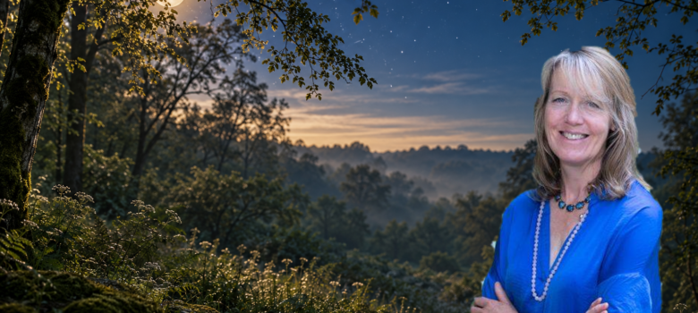 Rowana smiling in a moonlit woodland beneath an evening sky
